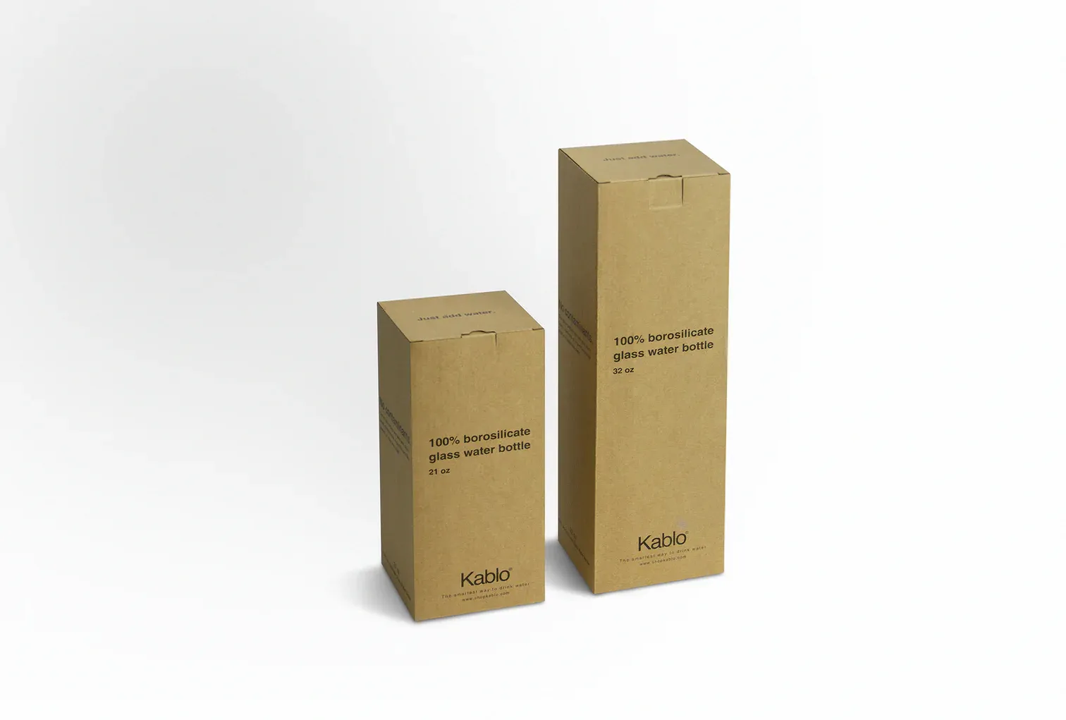 two cardboard boxes sitting side by side on a white surface