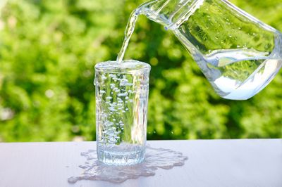 An overflowing glass of water, symbolizing overhydration
