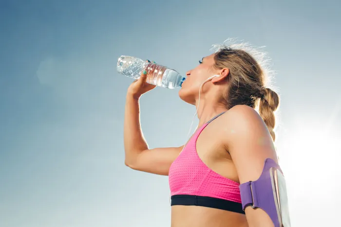 An active person drinking water from a bottle