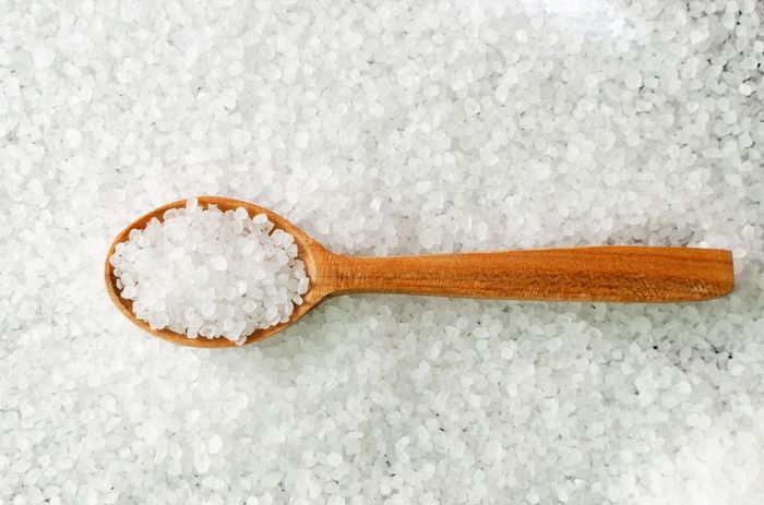A wooden spoon with salt that can be used to replenish electrolytes