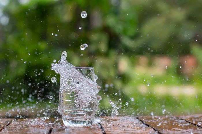 A glass being filled with rainwater.